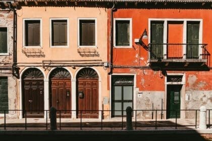 Two charming, old houses on a narrow street in Sicily, examples of cheap property for sale in Italy.