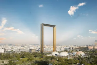 An investor reviewing documents for a UAE residency visa with a modern Dubai building in the background.