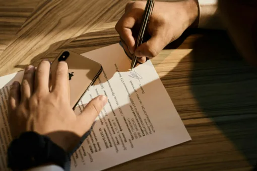 A person signing a power of attorney for a property purchase in Greece.