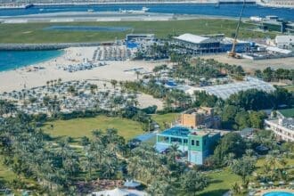 A panoramic view of a luxury villa community with lush green spaces in Dubai.