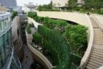 A modern residential building in Dubai featuring a lush vertical garden, symbolizing the wellness real estate trend.