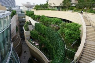 A modern residential building in Dubai featuring a lush vertical garden, symbolizing the wellness real estate trend.