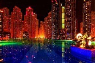 Night view of the Dubai skyline with illuminated skyscrapers, symbolizing the Dubai 2040 Master Plan.