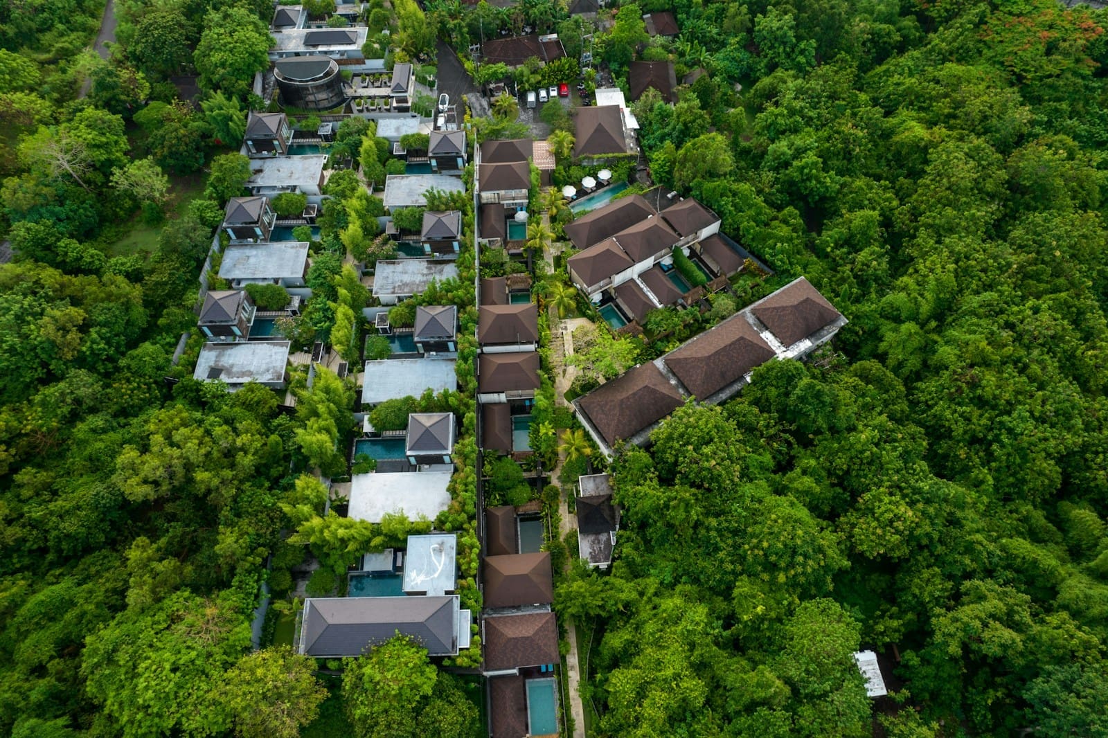 A modern residential complex with abundant greenery and trees, illustrating the "green premium" concept in sustainable real estate.