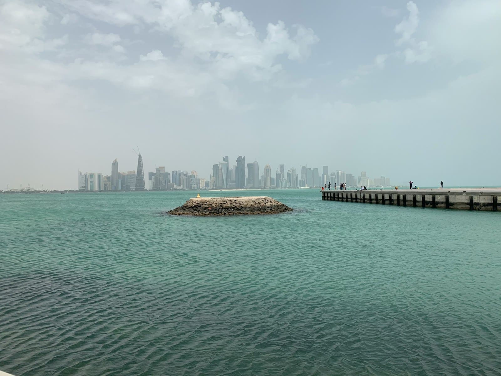 A composite view of the Dubai skyline, Abu Dhabi skyline, and Al Marjan Island in Ras Al Khaimah.