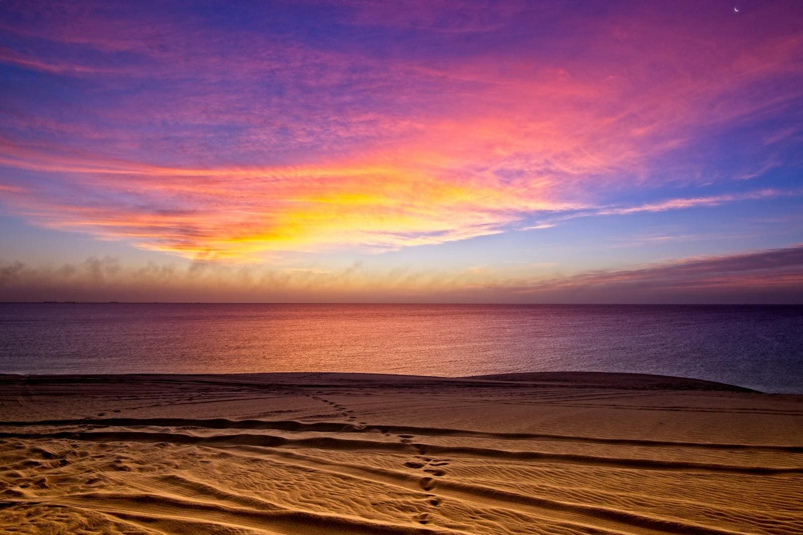 Панорамна снимка на плажа Umm Suqeim в Дубай с изглед към крайбрежната ивица и модерна инфраструктура.